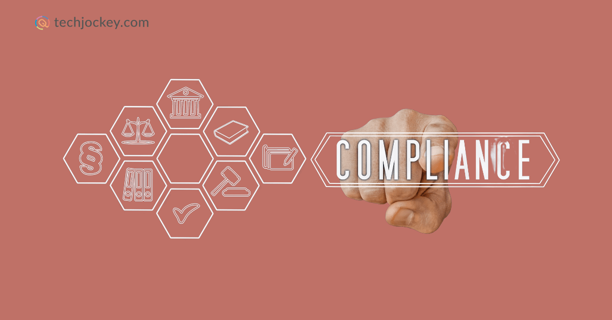 A hand pointing forward with the word COMPLIANCE highlighted, surrounded by hexagonal icons representing legal and regulatory elements like a courthouse, law book, gavel, and scales of justice, with the Techjockey.com logo in the corne