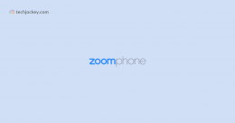 Zoom Phone logo displayed on a light blue background with techjockey.com branding in the corner.