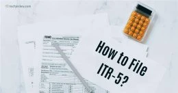 Flat lay image with paper tax forms, a calculator, and a sheet labeled 'How to File ITR-5?' intended as an introductory visual for an ITR filing guide