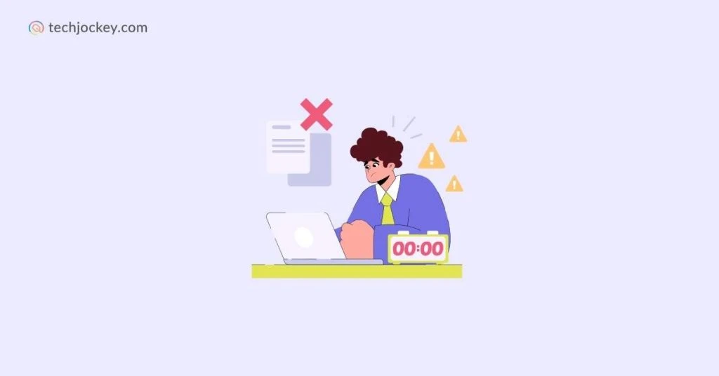 An illustration of a stressed office worker at a desk with a laptop and zero-timer clock, surrounded by warning signs and a large red cross, symbolizing missed deadlines or errors for techjockey.com.

