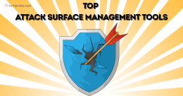 An illustration features a cracked blue shield pierced by a red arrow, symbolizing a security breach, with rays radiating outward in the background. The text above reads Top Attack Surface Management Tools, and a small techjockey.com logo is visible in the top-left corner.