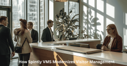 Office visitors checking in at a reception desk using Spintly VMS for modern contactless visitor management and secure building access