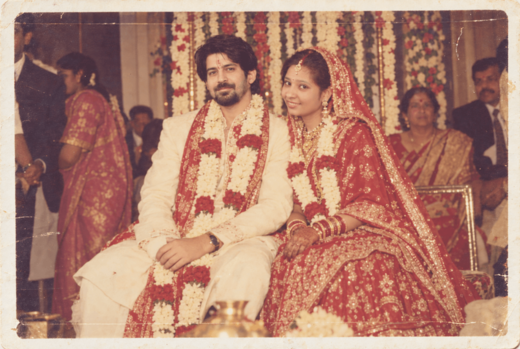 Vintage 1980s Indian wedding portrait of a newly married couple wearing traditional attire