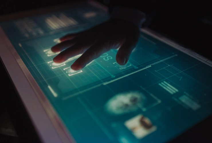 A hand on a screen validating biometrics.